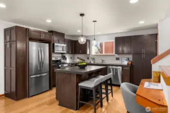New stainless steel appliances, ample storage in the cherry wood cabinetry and a half bath on the same floor.