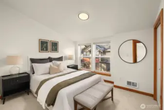 Primary bedroom on the upper level features fresh paint, new carpet and a full suite with a double sink vanity and a soaking tub/shower.