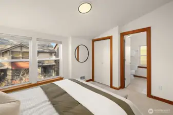 Primary bedroom features fresh paint, new carpet and a full suite with a double sink vanity and a soaking tub/shower.