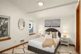 Secondary bedroom upstairs features custom built-in closet treatments, new carpet, fresh paint and a full ensuite.