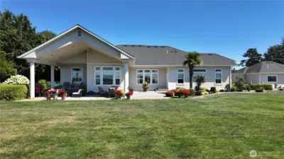 Back of home with large yard