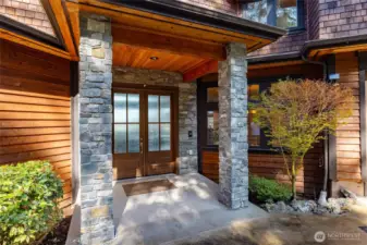 Gorgeous stone tiling at entry with oversize custom doors.