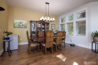 Formal dining area at "forest side" of home still has views across the living area.