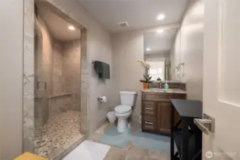 Upstairs 3/4 bath. The same stone tile was used throughout bathrooms for consistency.