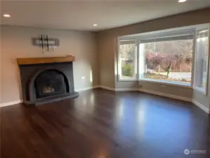 Living room with bay window and fireplace
