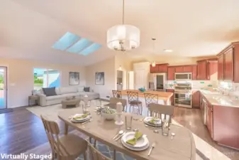 Pretty kitchen has quartz counters, tiled backsplash and stainless appliances