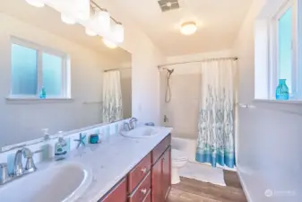 Primary bathroom with double sinks and tub