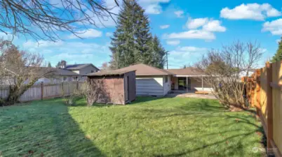 Mostly-fenced, flat, and spacious backyard offers endless possibilities for usage!