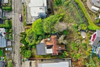 Aerial of house on lot w/home to the west behind subject property