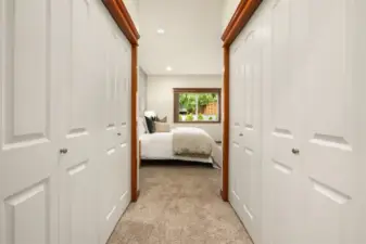 Primary double closets between bedroom and attached bathroom.
