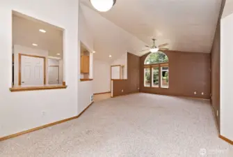 Vaulted ceilings and arch windows in living room let a lot of natural light in and make the home live large.