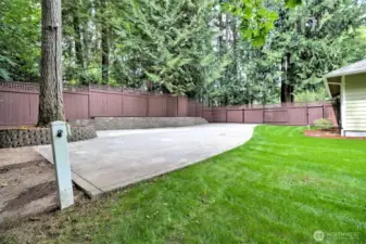 Large concrete pad for RV parking with electrical and water hookups.
