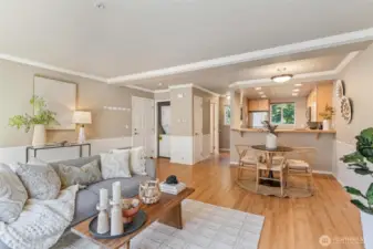 Bright and airy living room with oversized windows, sleek vinyl plank flooring.