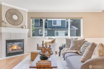 Light-filled living room with vaulted ceilings and a cozy fireplace.
