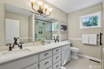 Remodeled guest bathroom with full size tiled, walk-in shower.