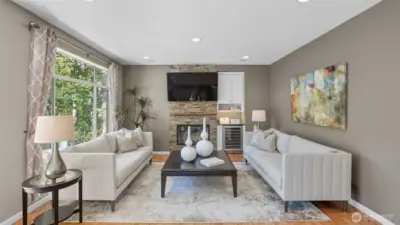 A spacious Family room boasts wood burning fireplace with slate surround and mantle.  The is a perfect spot for a large screen TV and it has a built-in beverage cooler.