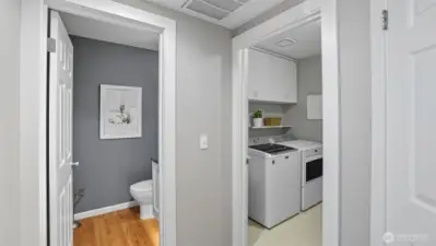 Shows the utility room and the powder room proximate then the location of the 2 car garage through the utility room.