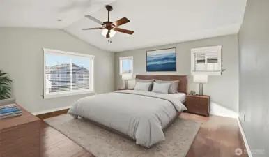 Bright and spacious primary bedroom features double-door entry, vaulted ceilings with fan and more. (virtually staged)