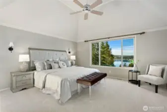Luxurious primary suite with vaulted ceilings and breathtaking lake views - a private retreat.