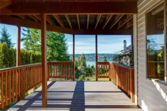 Private covered new deck off the lower-level bonus room, offering tranquil territorial and water views — perfect for year-round outdoor living.
