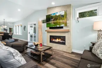 Cozy gas fireplace feature wall anchors the living room, creating a warm and welcoming space for relaxing evenings.