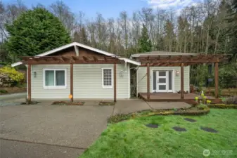 Welcoming curb appeal at this move-in ready Skyline rambler in Anacortes, featuring covered pergolas, inviting entry, and easy single-level living set on a quiet cul-de-sac.