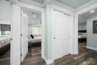 Wide hallway with beautiful millwork and durable flooring leads to the private bedroom wing of the home.