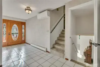 Bright interior entry with convenient access to upper and lower levels, creating a welcoming first impression.