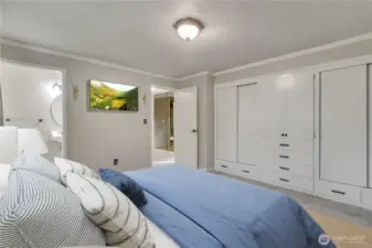 Generous storage with built-in cabinetry and ample closet space keeps everything organized . Notice the private, ensuite, tiled bathroom just to the left. **VIRTUALLY STAGED**