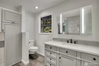 Updated vanity and modern finishes create a bright and functional main bathroom space. And yes---another garden window!