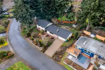 Bird’s-eye view highlights the home’s attractive landscaping and spacious lot. You can also see the beautiful paved driveway---spectacular! A one-of-a kind!
