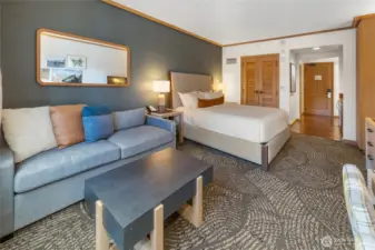 King bed with plush resort bedding and warm lighting