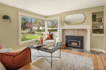 The corner windows bring in the western exposure and natural light that flood the room. The tiled fireplace and hearth provide a nice textural contrast to the painted millwork.