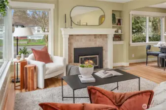 Just off the living room is the dining room and kitchen. Built-in shelving is to the right of the gas fireplace.