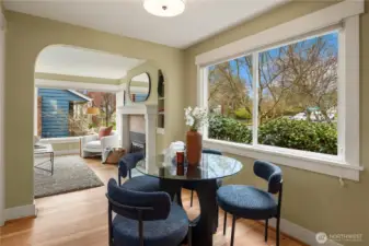 The dining room looks out over the beautifully landscaped front yar through the oversized window.