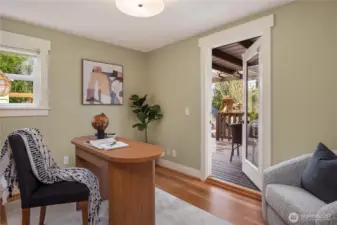 The second bedroom on the main level features a french door that leads to the back deck. Another door off the kitchen also takes you to the back deck and backyard.