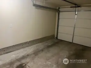 The garage is a nice size and has a storage area in front of the parking area.