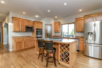 Another view of the kitchen with built-in wine racks.