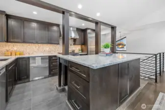 A spacious kitchen island with exquisite quartz countertops provides ample prep space and additional storage.