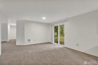 ~ View of dining area as you exit kitchen ... Hallway on left takes you to Primary Suite w/private half bath and third bedroom and full bath. ~