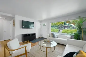 Big windows all with slatted shades allow verdant views of the neighborhood and garden.