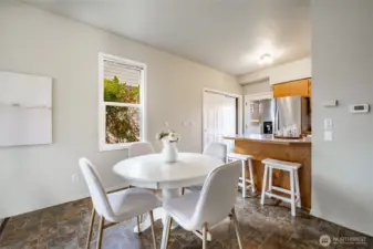 Dining area and breakfast bar. Closet near back door has laundry and a 2nd fridge.