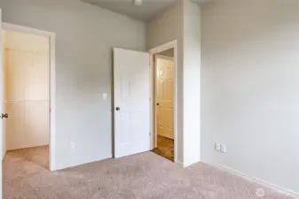 First floor bedroom with walk-in closet with a window.