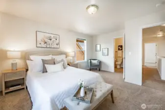 Primary bedroom with adjoining bath. So much great light in this home!