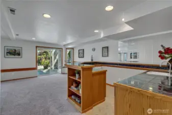 lower level rec room with wet bar and doors to the patio.