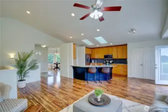 Living room looking towards entry, kitchen and dining area.
