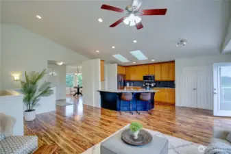 Living room looking towards entry, kitchen and dining area.