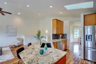 Kitchen has ample granite counter space, maple cabinets and stainless steel appliances.