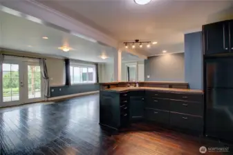 This spacious lower level has a kitchen with fridge and sink. Open to bonus room. Opportunities are endless in what you can create with all this space.