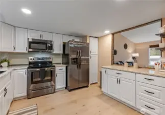 Upgraded kitchen with granite counters, upgraded appliances and new flooring